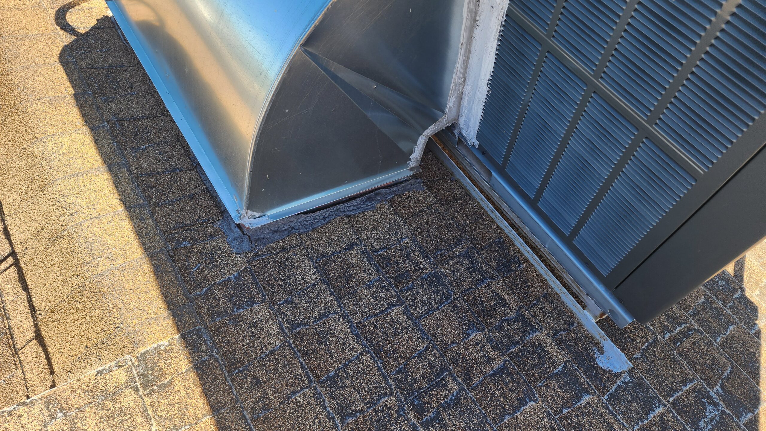 Roof leak around AC unit on asphalt shingle roof in Phoenix Arizona showing failed flashing and sealant
