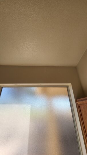 ceiling water stain above window roof leak